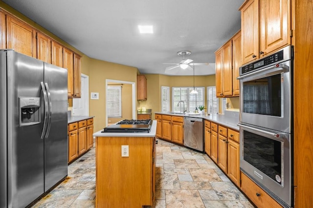2610 Chadwick Rd, Marietta, GA 30066 - kitchen with stainless steel appliances, stone tile flooring, a sink, and a kitchen island