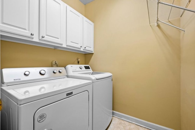 2610 Chadwick Rd, Marietta, GA 30066 - laundry room with washer and clothes dryer, cabinet space, baseboards, and light tile patterned flooring