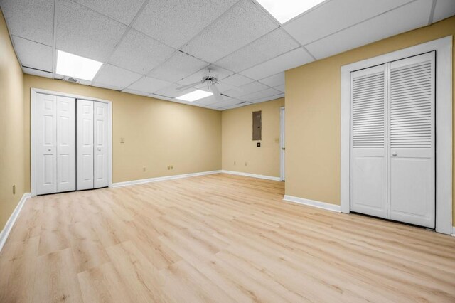 2610 Chadwick Rd, Marietta, GA 30066 - unfurnished bedroom with two closets, light wood-style flooring, baseboards, a paneled ceiling, and a ceiling fan