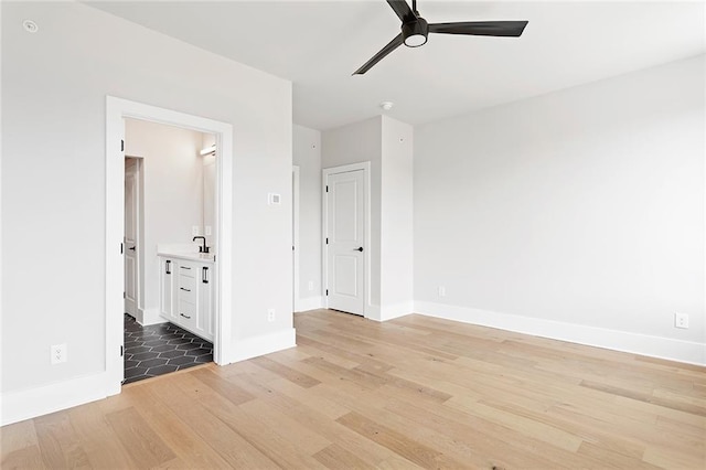 7210 Summit Pl, Alpharetta, GA 30009 - unfurnished bedroom featuring light wood finished floors, baseboards, ensuite bath, and ceiling fan