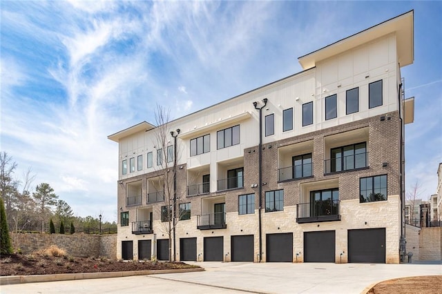 7210 Summit Pl, Alpharetta, GA 30009 - view of building exterior featuring an attached garage and driveway