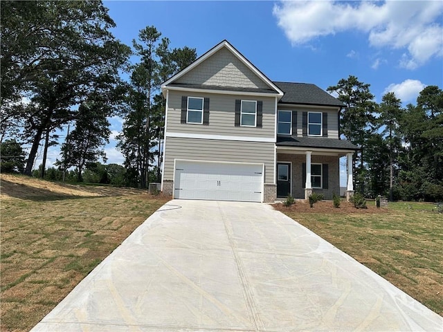 craftsman-style house featuring a garage, brick siding, driveway, and a front lawn