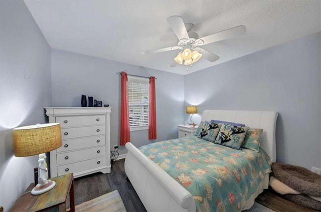 bedroom with dark wood-type flooring and ceiling fan