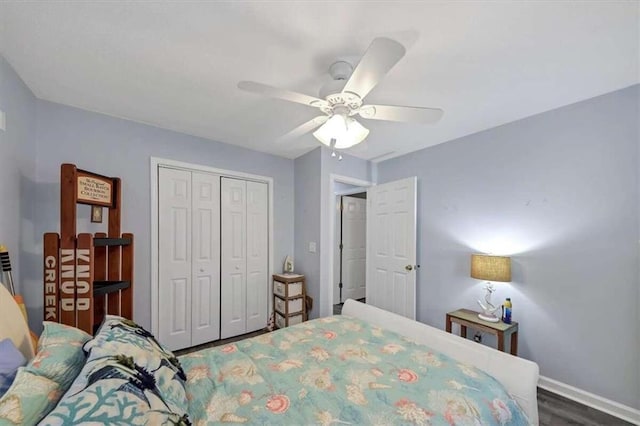 bedroom with a closet, dark wood-type flooring, and ceiling fan