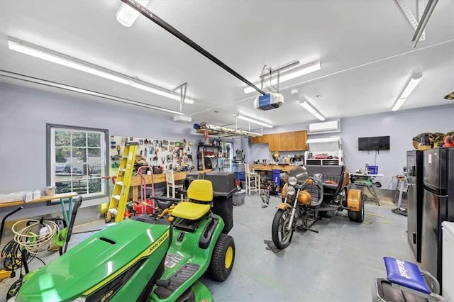 garage featuring a garage door opener, a wall unit AC, and a workshop area