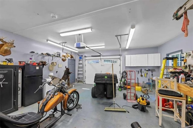 garage featuring a garage door opener and black fridge