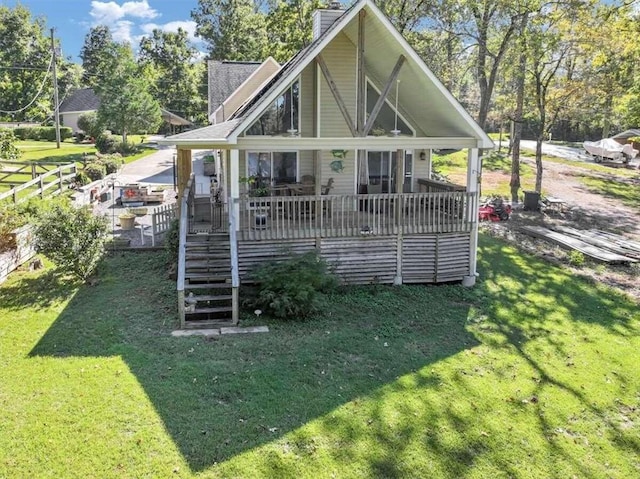 back of house featuring a deck and a yard