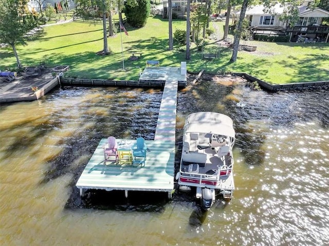 dock area with a water view and a lawn