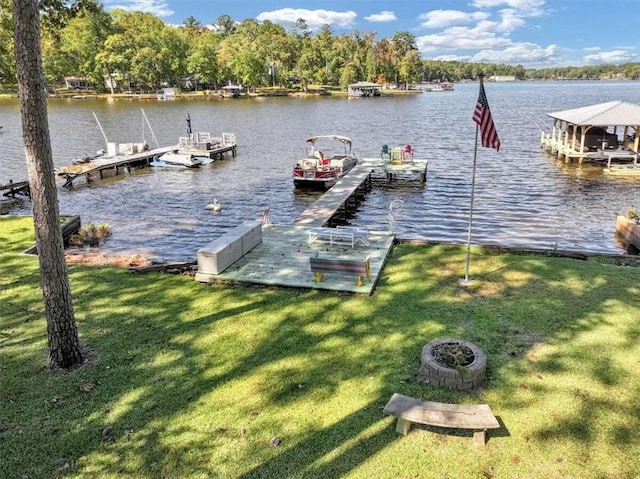 dock area featuring a lawn and a water view