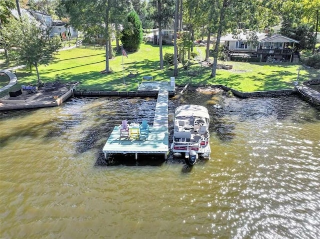 view of dock featuring a yard and a water view