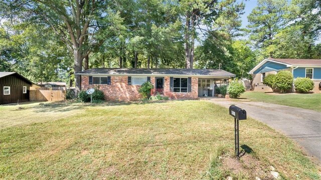 ranch-style home with a front lawn