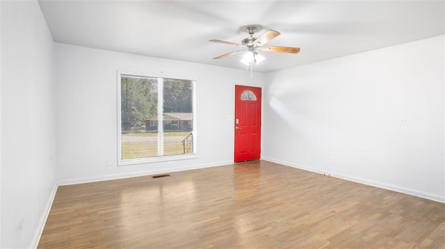 empty room featuring ceiling fan and hardwood / wood-style floors