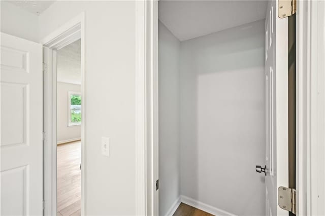 interior space with baseboards and wood finished floors