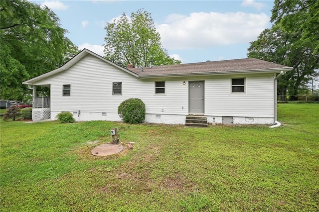 back of property featuring a yard, roof with shingles, entry steps, and crawl space