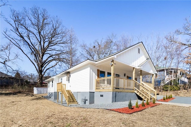 view of side of home featuring covered porch