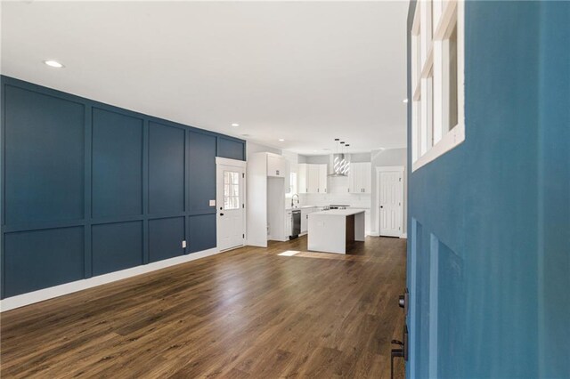 interior space with a decorative wall, dark wood-type flooring, and recessed lighting