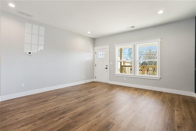 interior space with recessed lighting, baseboards, and wood finished floors