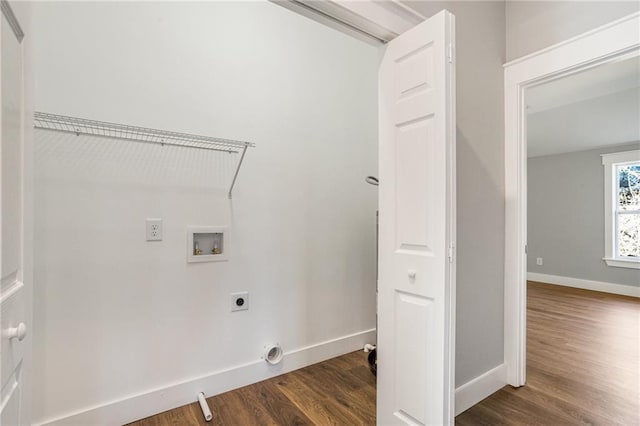 laundry room featuring dark wood-type flooring, hookup for a washing machine, and electric dryer hookup