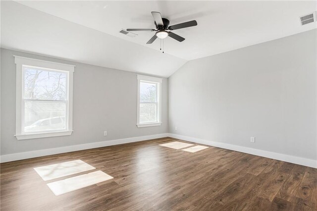 spare room with lofted ceiling, dark hardwood / wood-style floors, and ceiling fan