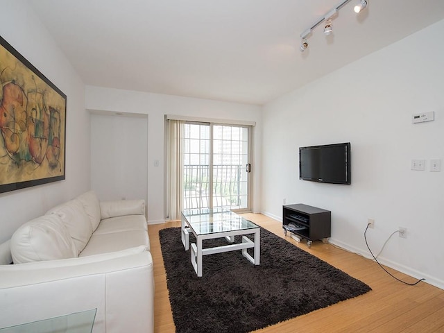 199 14th St NE Unit 1209, Atlanta, GA 30309 - living area with light wood-type flooring, baseboards, and track lighting