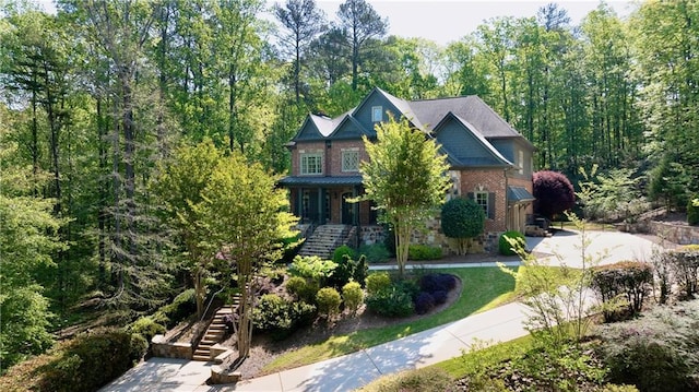 exterior space featuring stairs and brick siding