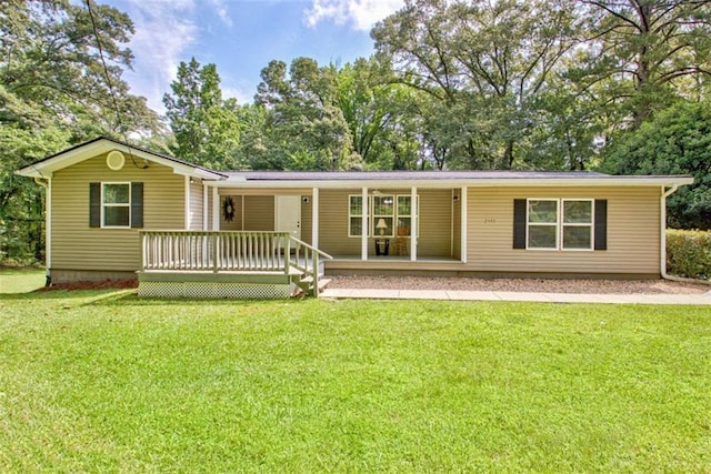3440 Wilson Rd, South Fulton, GA 30349 - view of front facade featuring a front yard, covered porch, and view of wooded area
