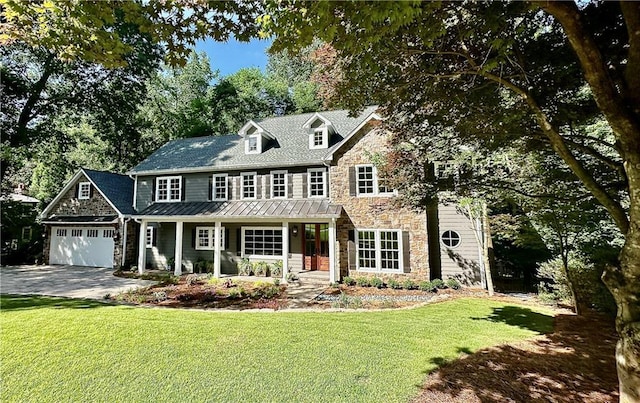 view of front of house with a front lawn, a porch, and a garage