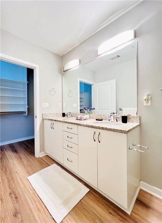 400 W Peachtree St NW Unit 2704, Atlanta, GA 30308 - full bathroom with wood finished floors and double vanity