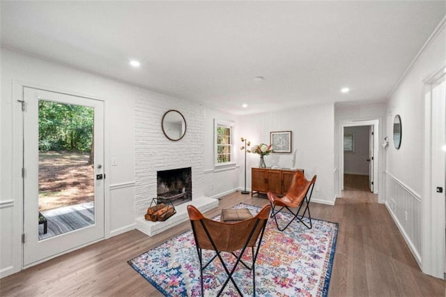 living room featuring hardwood / wood-style floors, a fireplace, and plenty of natural light