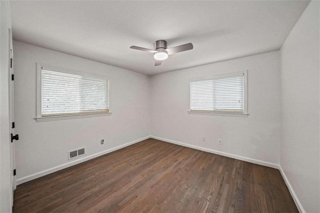 empty room featuring ceiling fan and dark hardwood / wood-style flooring