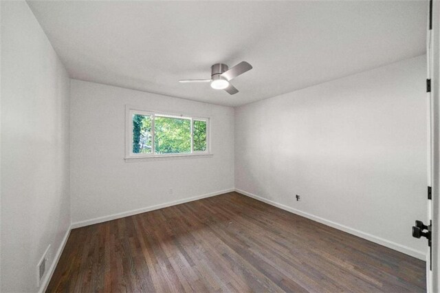 empty room featuring dark wood-type flooring and ceiling fan