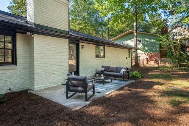 rear view of house with a patio area and outdoor lounge area