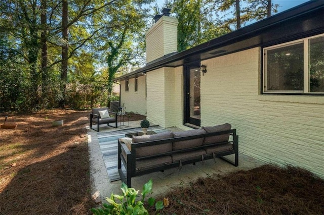 view of side of property with a patio area and an outdoor hangout area