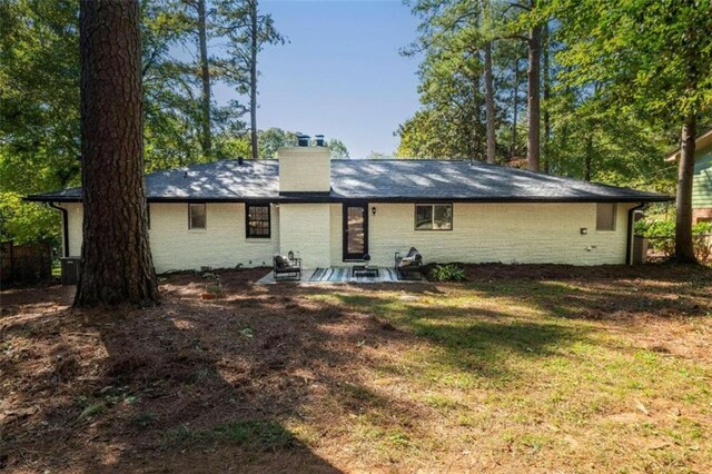 back of house with a yard and a patio