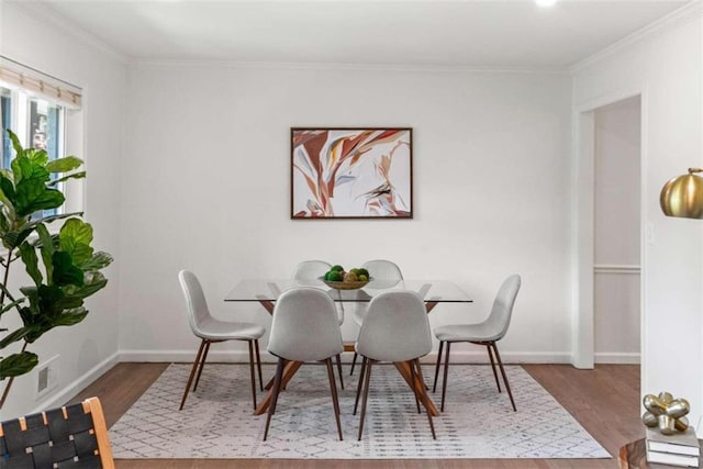 dining room featuring crown molding and wood-type flooring