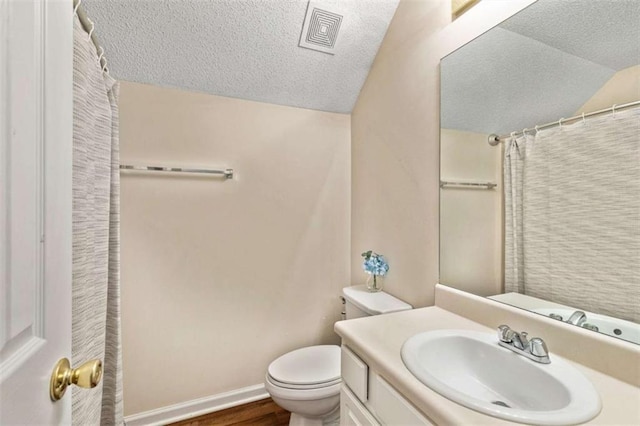50 Emerald Hills Ln, Newnan, GA 30263 - bathroom featuring visible vents, a textured ceiling, lofted ceiling, and toilet