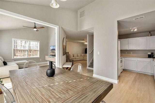 50 Emerald Hills Ln, Newnan, GA 30263 - dining area featuring a ceiling fan, visible vents, baseboards, stairs, and light wood-style flooring