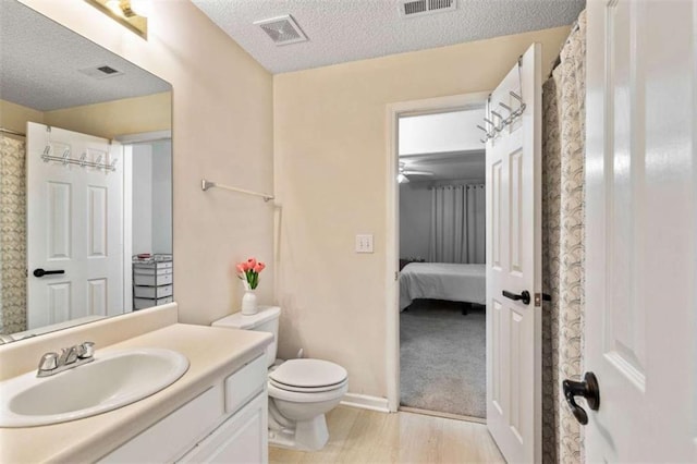 50 Emerald Hills Ln, Newnan, GA 30263 - full bath featuring vanity, toilet, a textured ceiling, wood finished floors, and visible vents