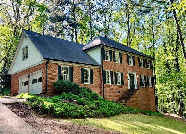 1461 Fox Forest Ter SW, Lilburn, GA 30047 - colonial house with brick siding, concrete driveway, and a garage