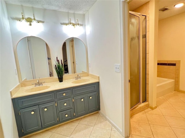 1461 Fox Forest Ter SW, Lilburn, GA 30047 - bathroom featuring tile patterned floors, a stall shower, double vanity, and a textured ceiling