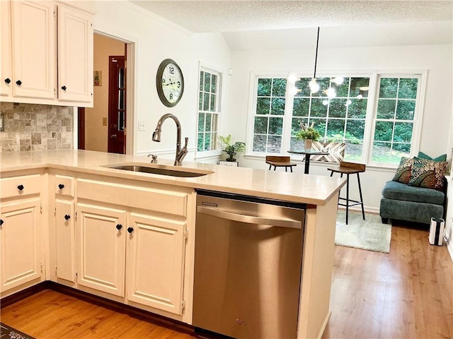 1461 Fox Forest Ter SW, Lilburn, GA 30047 - kitchen with dishwasher, a sink, light wood-type flooring, light countertops, and a textured ceiling