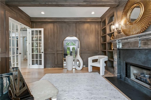 6225 Random Winds Blf, Gainesville, GA 30506 - sitting room featuring wood finished floors, french doors, arched walkways, a high end fireplace, and beam ceiling