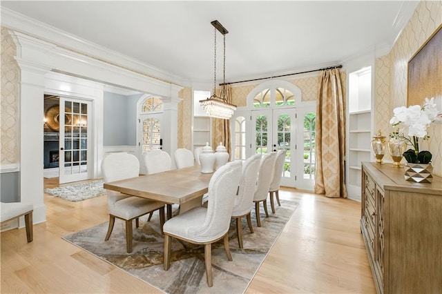 6225 Random Winds Blf, Gainesville, GA 30506 - dining room featuring french doors, ornamental molding, wainscoting, light wood-style floors, and wallpapered walls