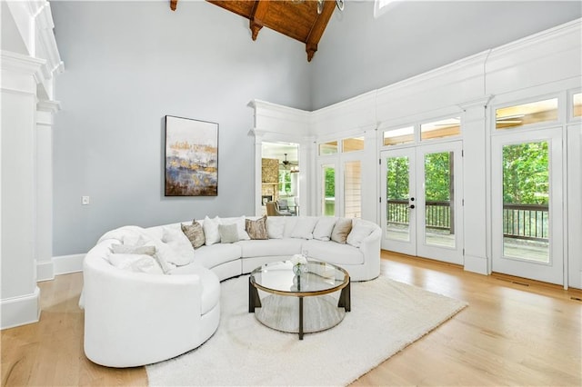 6225 Random Winds Blf, Gainesville, GA 30506 - living room with high vaulted ceiling, light wood-type flooring, beamed ceiling, decorative columns, and french doors