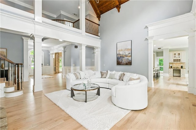6225 Random Winds Blf, Gainesville, GA 30506 - living room with ornate columns, light wood finished floors, high vaulted ceiling, beamed ceiling, and stairs