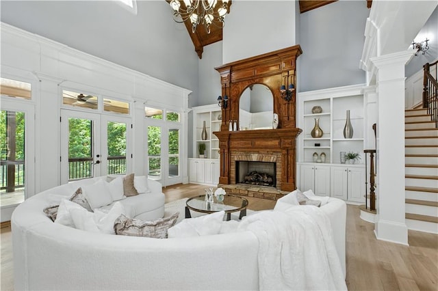 6225 Random Winds Blf, Gainesville, GA 30506 - living area featuring high vaulted ceiling, stairs, light wood-style flooring, a chandelier, and a fireplace