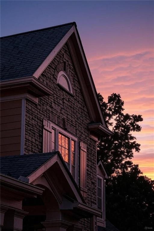 6225 Random Winds Blf, Gainesville, GA 30506 - property exterior at dusk featuring stone siding and roof with shingles