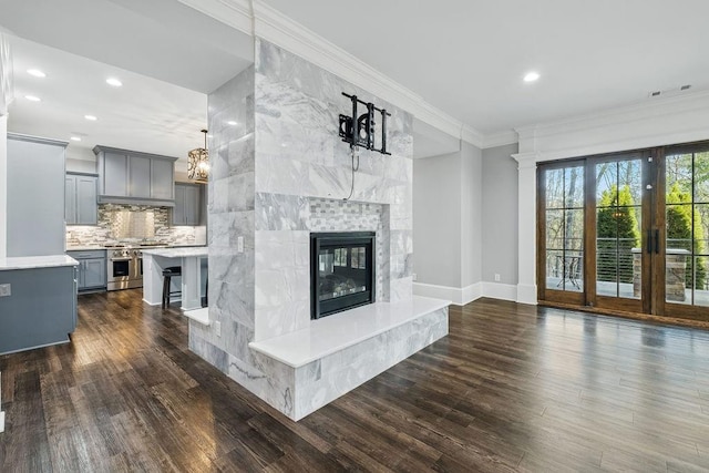 6225 Random Winds Blf, Gainesville, GA 30506 - unfurnished living room featuring dark wood-style flooring, a premium fireplace, crown molding, and recessed lighting