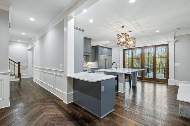 6225 Random Winds Blf, Gainesville, GA 30506 - kitchen with gray cabinets, a kitchen bar, ornamental molding, recessed lighting, and a center island with sink