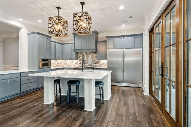 6225 Random Winds Blf, Gainesville, GA 30506 - kitchen with appliances with stainless steel finishes, gray cabinetry, ornamental molding, tasteful backsplash, and an island with sink